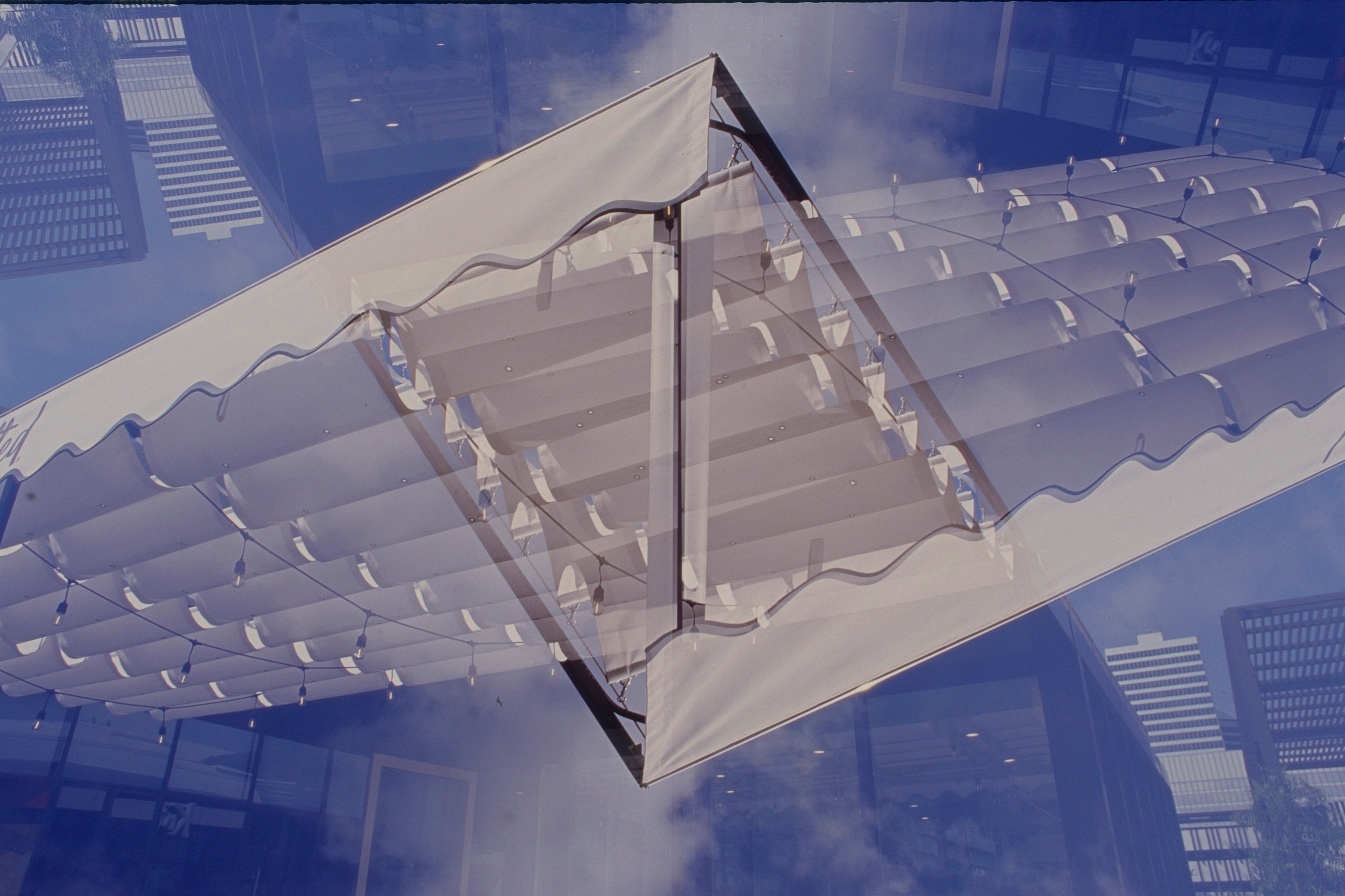 White tent canopy against a saturated blue sky