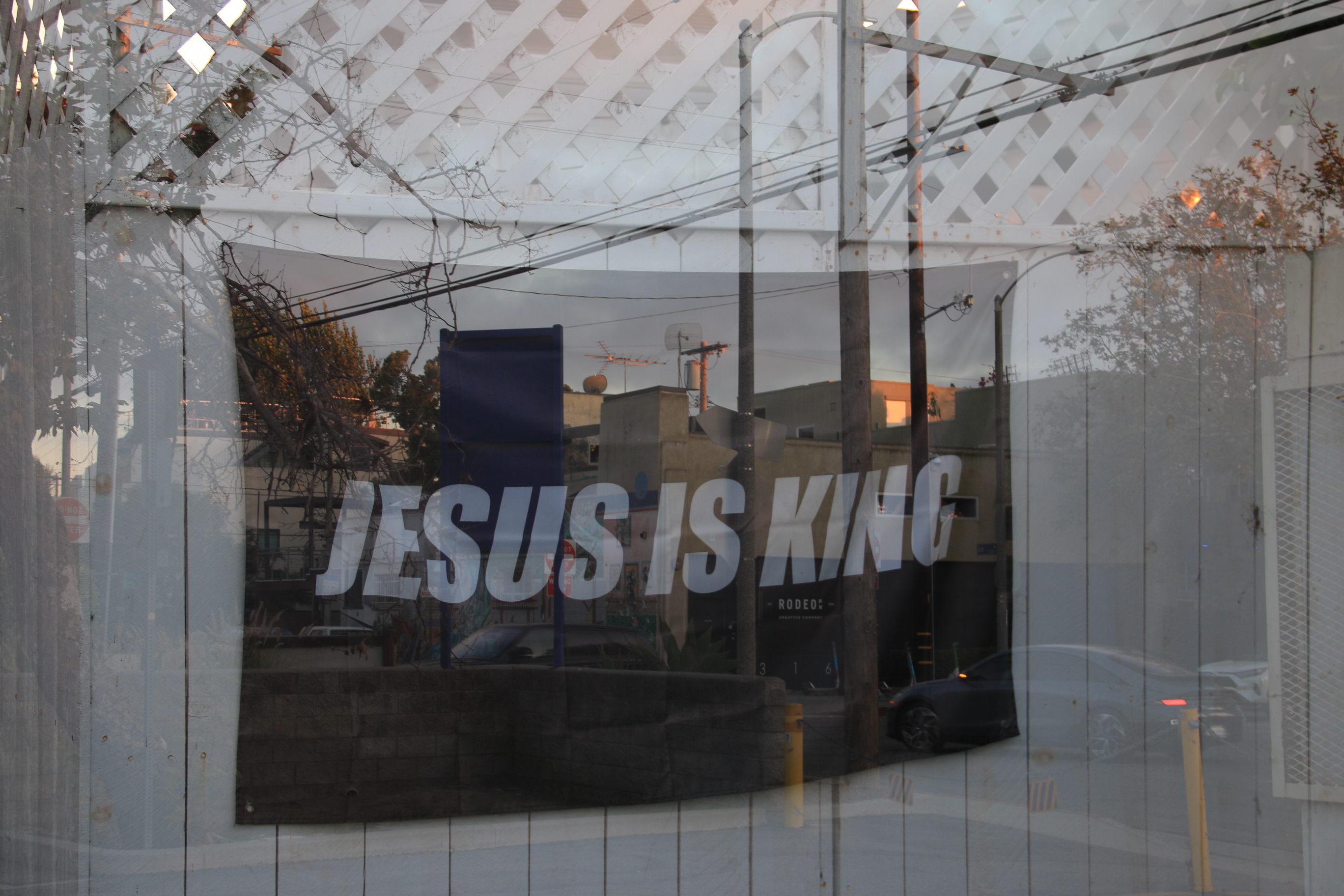 Jesus Is King mural layered with an upside-down Venice street